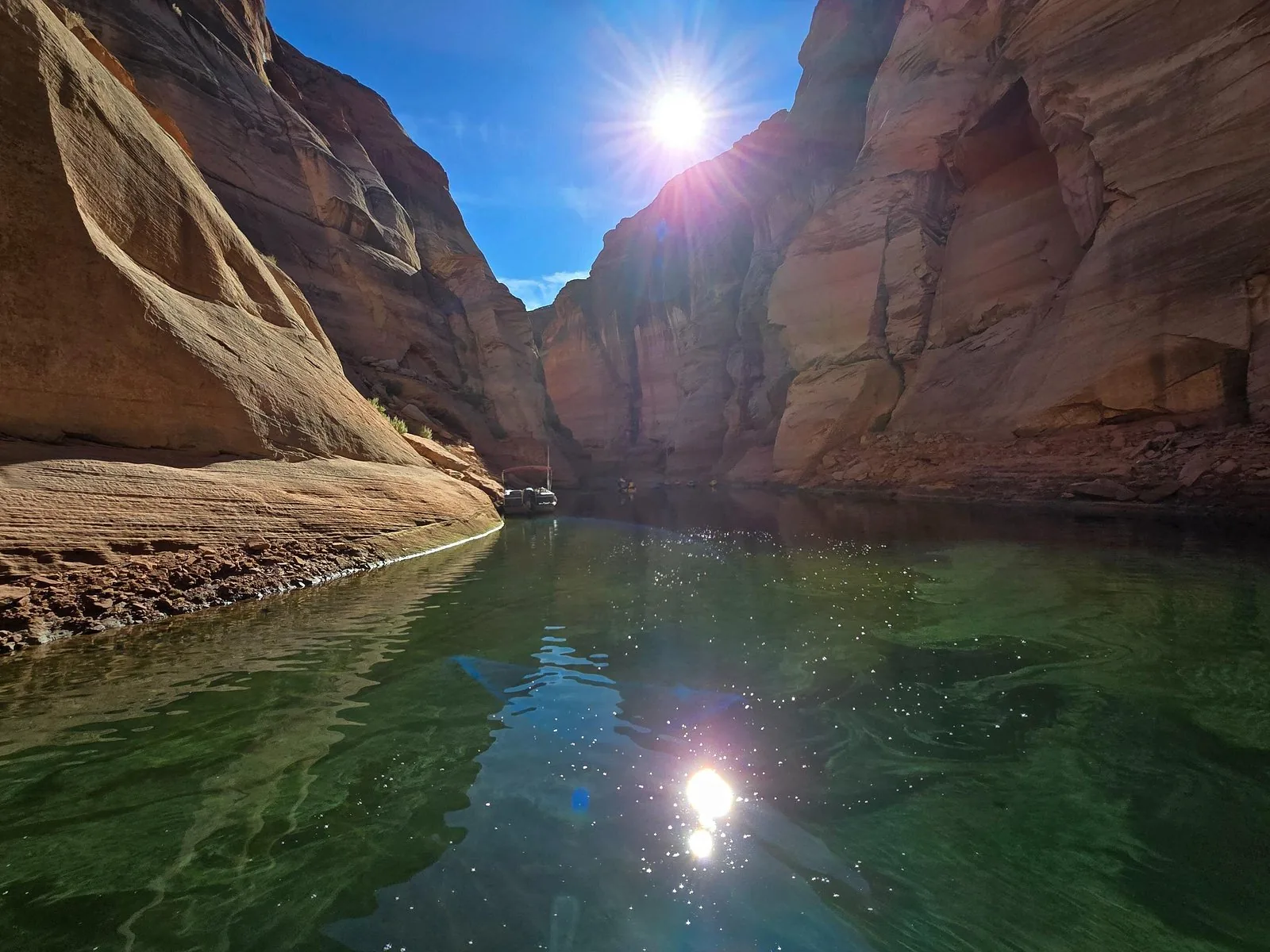 A Navajo guide leading travellers along Antelope Canyon's narrow corridor